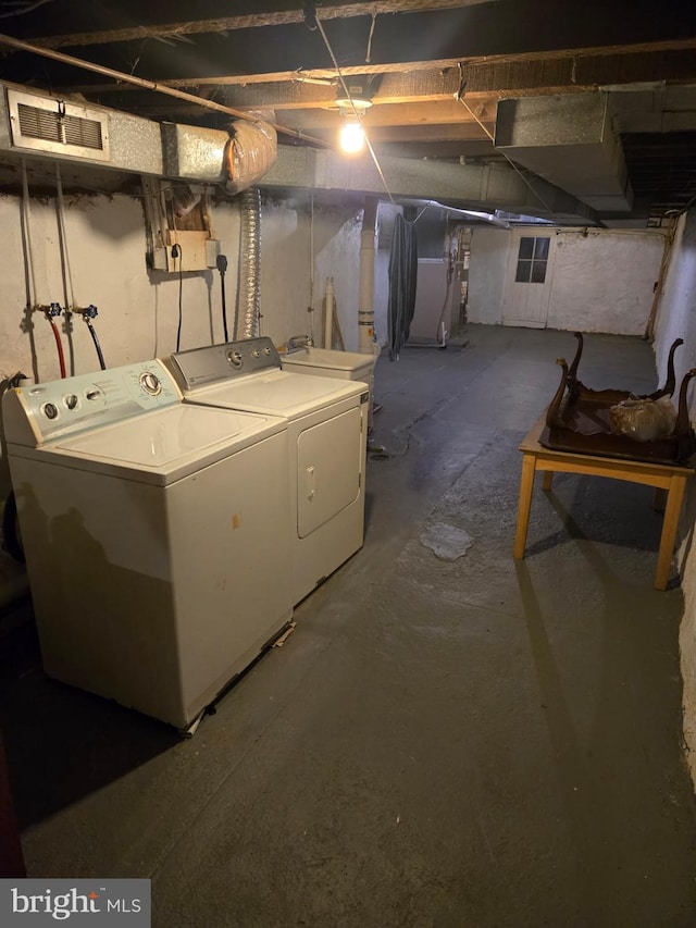 basement featuring washer and dryer and sink