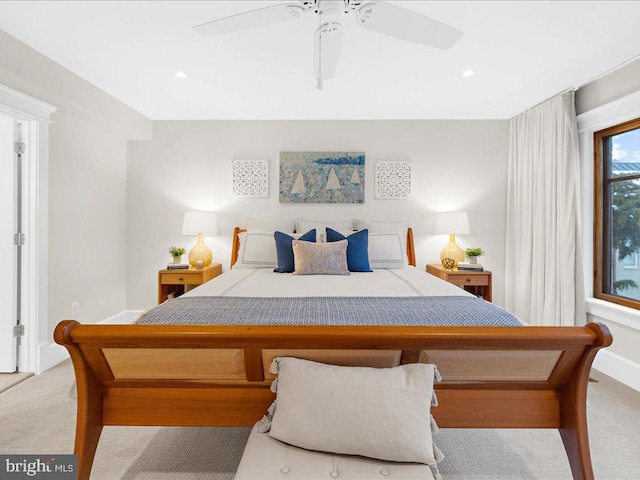 bedroom featuring light colored carpet and ceiling fan