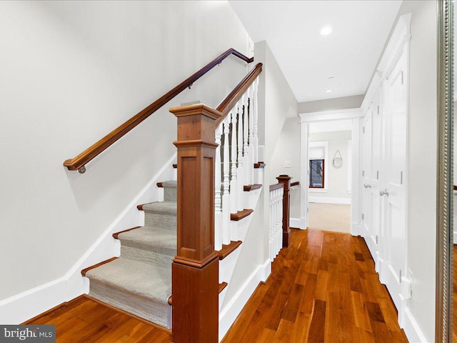 stairs featuring hardwood / wood-style flooring