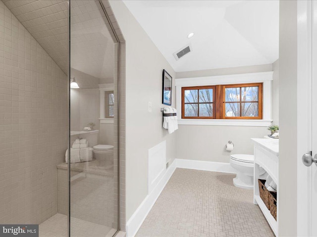 bathroom with vanity, toilet, and lofted ceiling