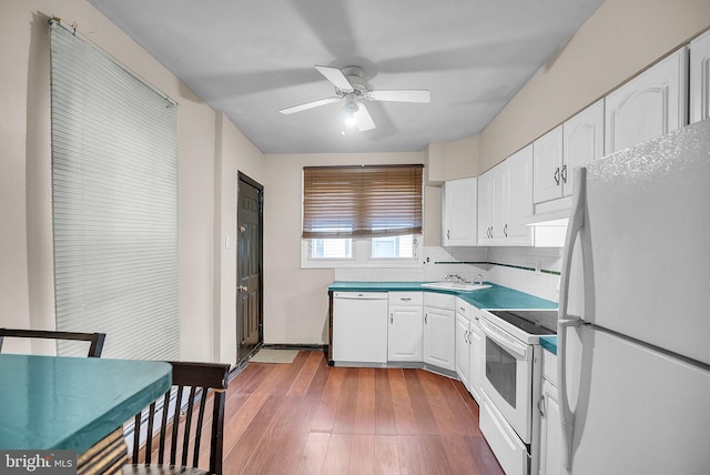 kitchen featuring white appliances, ceiling fan, sink, white cabinetry, and backsplash