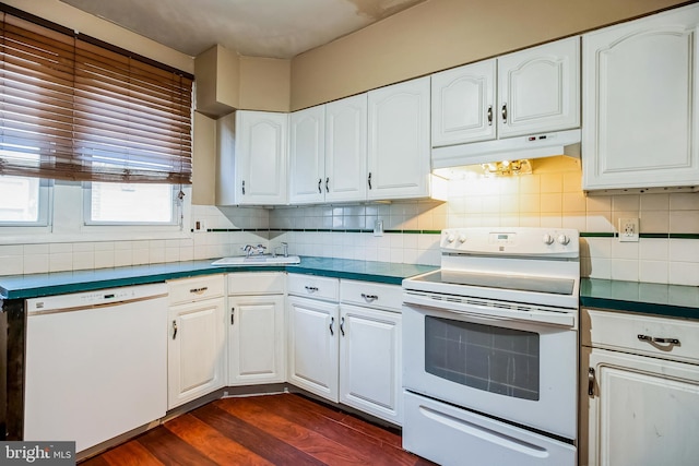 kitchen featuring white appliances, decorative backsplash, dark hardwood / wood-style flooring, white cabinets, and sink