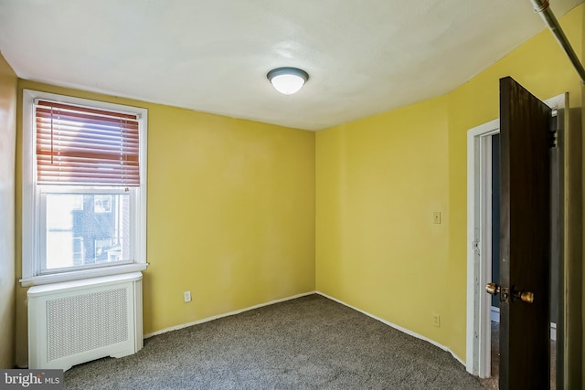 carpeted empty room with radiator