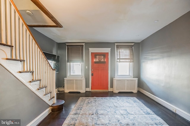 foyer featuring dark wood-type flooring and radiator