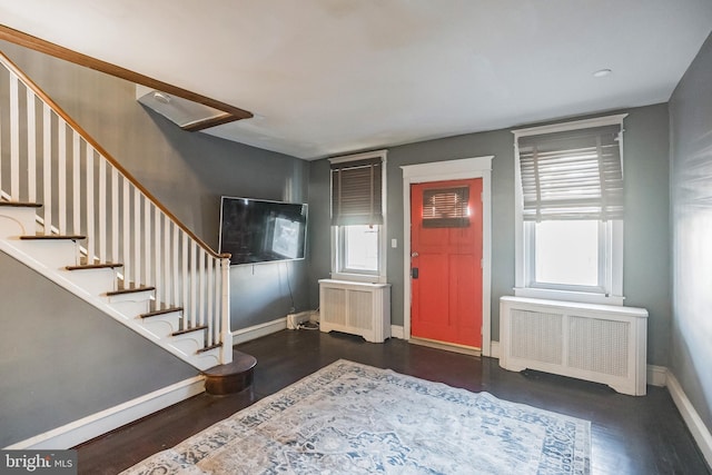 entrance foyer featuring radiator heating unit and dark hardwood / wood-style floors