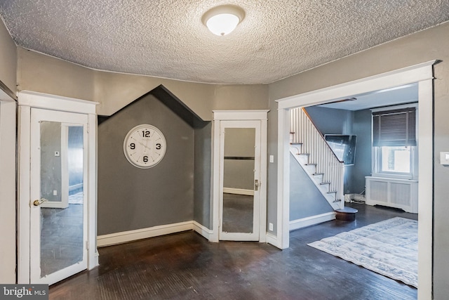 doorway to outside with radiator and a textured ceiling