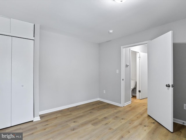 unfurnished bedroom featuring a closet and light hardwood / wood-style floors