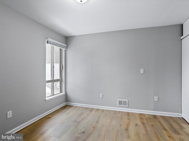 spare room with a wealth of natural light and light hardwood / wood-style flooring