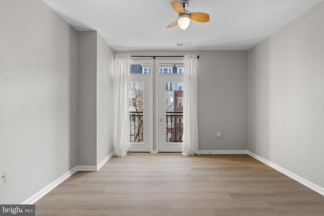 spare room featuring light hardwood / wood-style flooring and ceiling fan