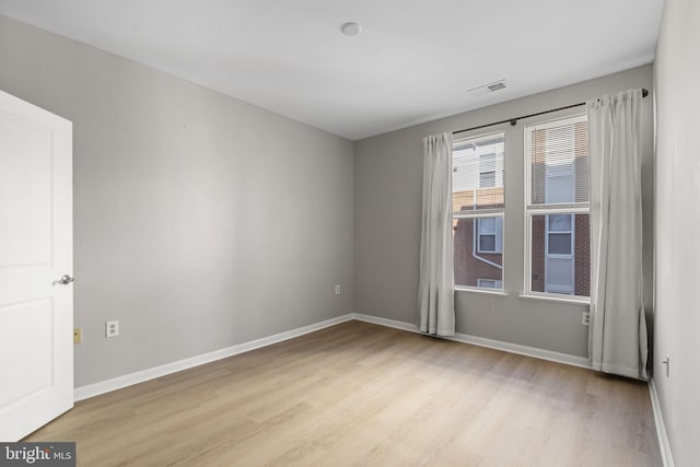 spare room with light hardwood / wood-style floors