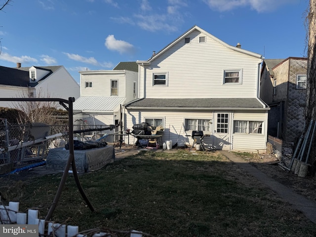 rear view of house with a yard