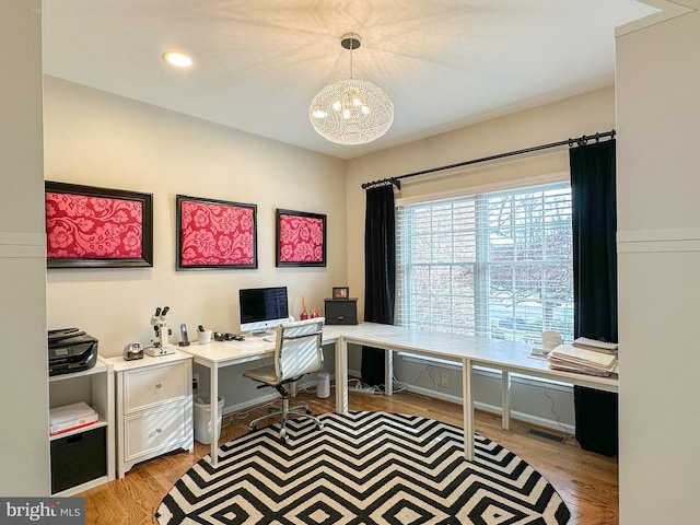 office area featuring a chandelier and light wood-type flooring