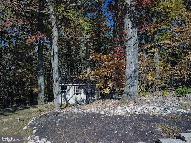 view of gate featuring an outbuilding