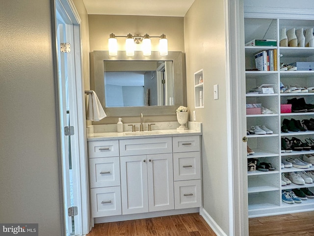 bathroom with hardwood / wood-style flooring and vanity