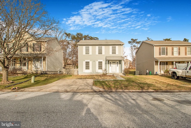 colonial inspired home featuring central AC and a front yard