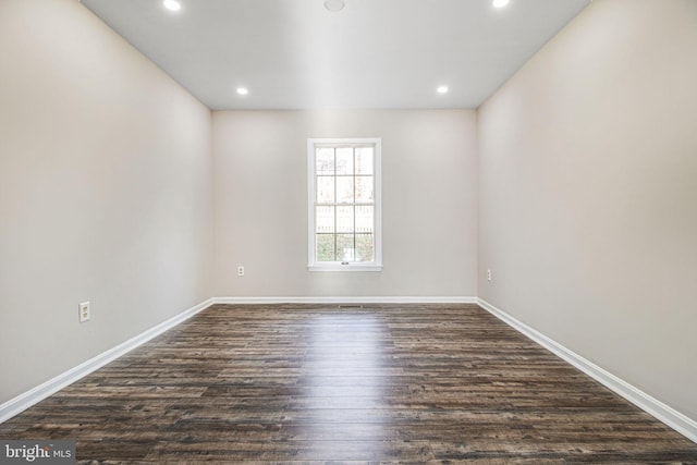 spare room with dark hardwood / wood-style floors