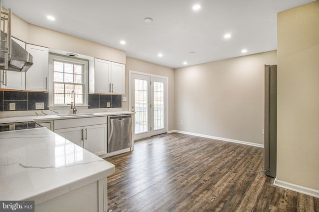 kitchen featuring sink, white cabinets, stainless steel dishwasher, and dark hardwood / wood-style floors