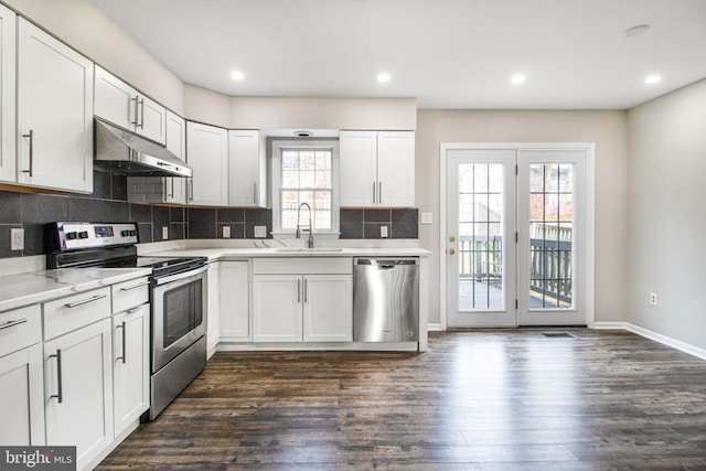 kitchen featuring appliances with stainless steel finishes, dark hardwood / wood-style floors, white cabinets, and sink