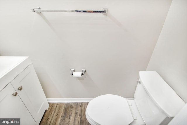 bathroom featuring hardwood / wood-style floors, vanity, and toilet