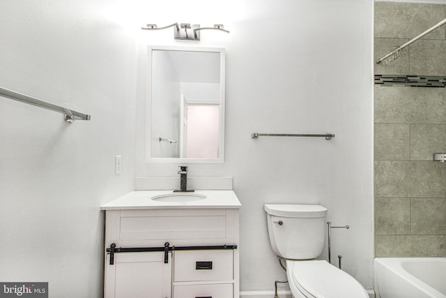 full bathroom featuring toilet, tiled shower / bath, and vanity