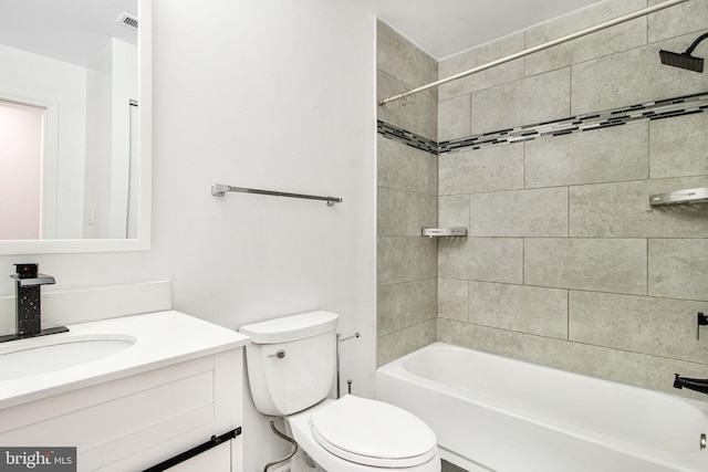 full bathroom with toilet, tiled shower / bath, and vanity