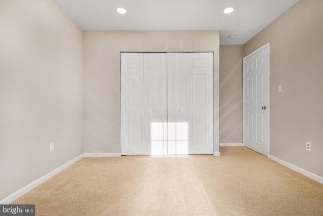 unfurnished bedroom with a closet and carpet