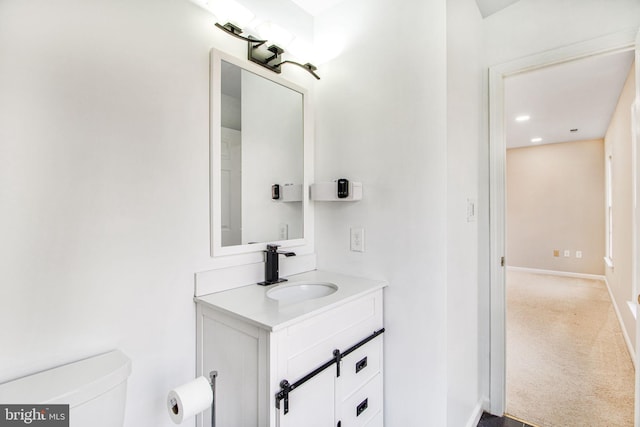 bathroom featuring vanity and toilet