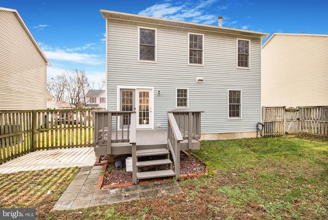 back of property featuring a patio, a yard, and a wooden deck