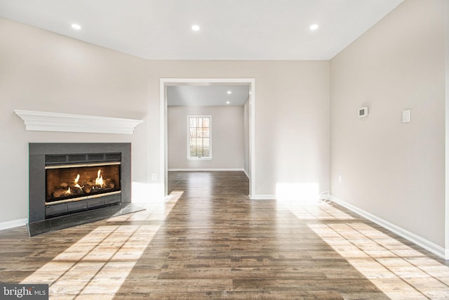 unfurnished living room featuring wood-type flooring