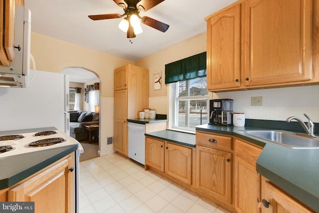 kitchen with white appliances, ceiling fan, and sink