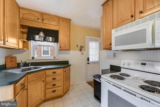 kitchen featuring decorative light fixtures, sink, white appliances, and a healthy amount of sunlight