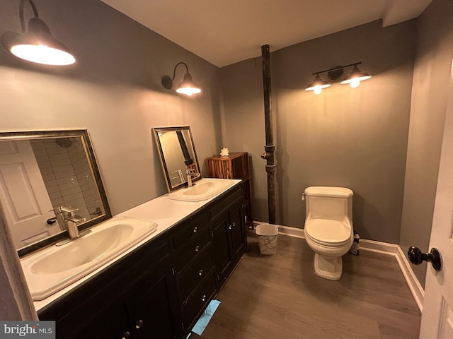 bathroom with hardwood / wood-style flooring, vanity, and toilet