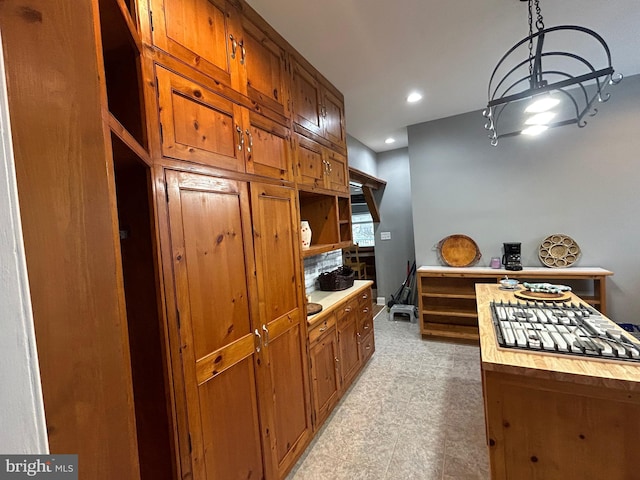 kitchen featuring pendant lighting and wooden counters