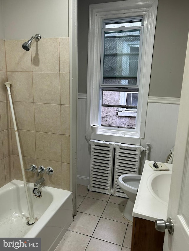 full bathroom featuring toilet, tiled shower / bath combo, tile patterned flooring, and vanity