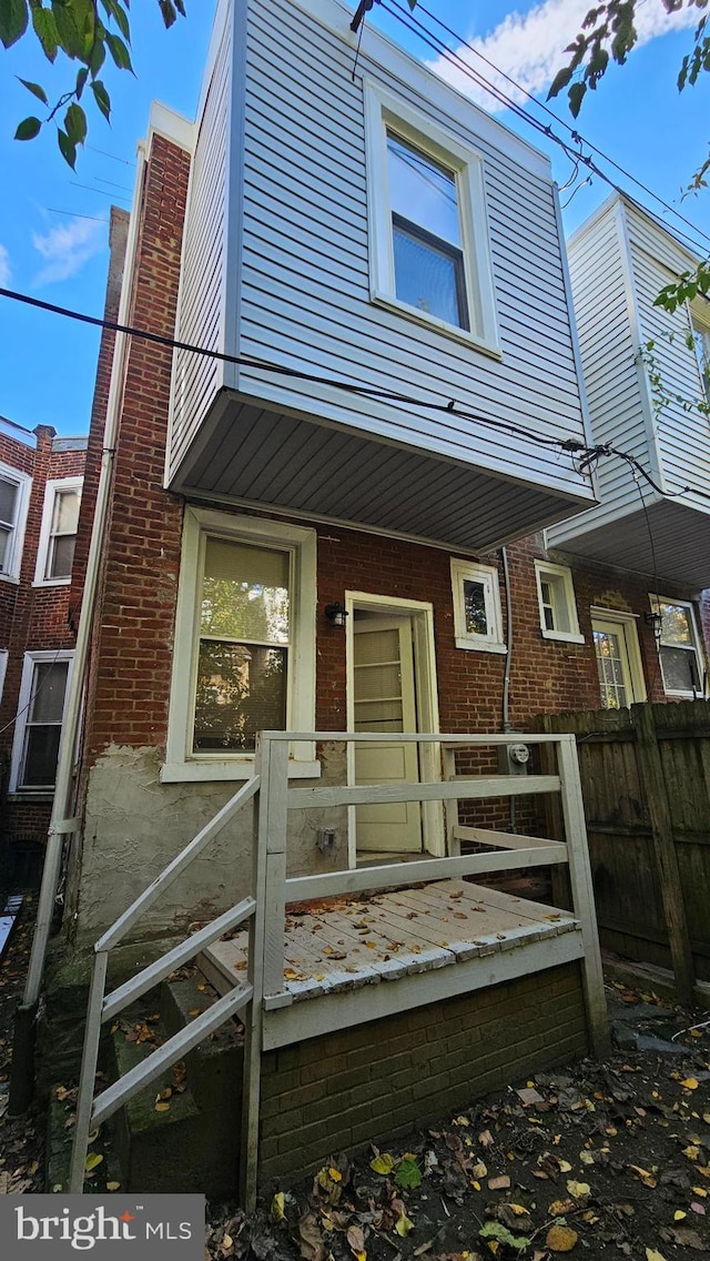 rear view of house featuring covered porch