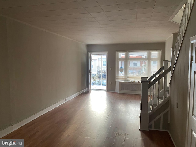 entryway featuring hardwood / wood-style floors and crown molding