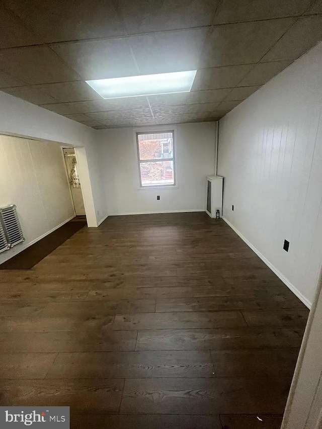 basement featuring dark hardwood / wood-style flooring