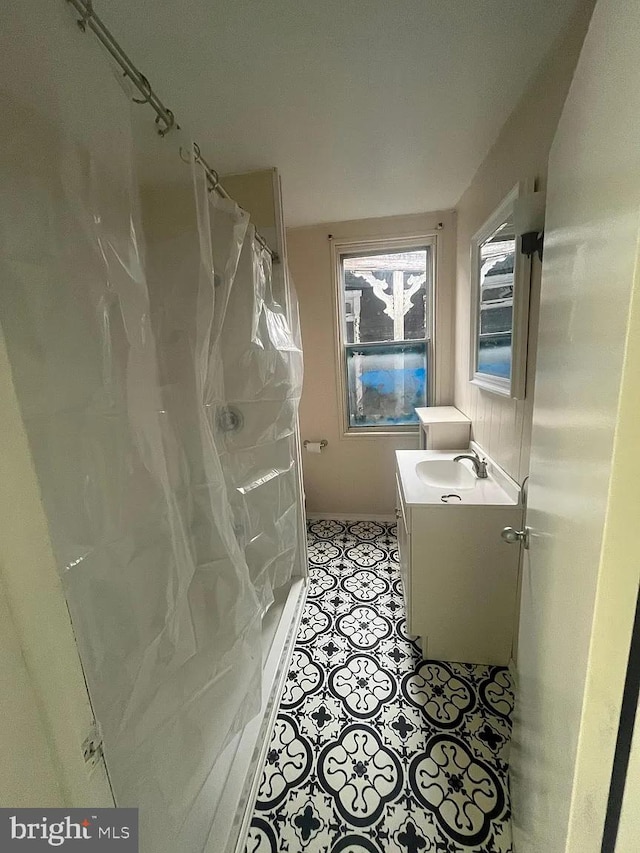 bathroom featuring vanity and curtained shower