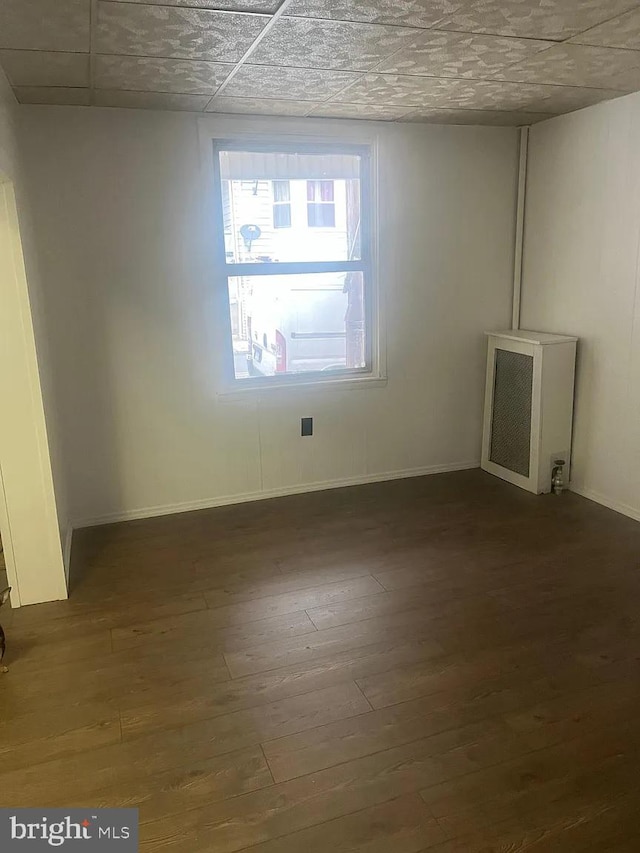 unfurnished room with dark hardwood / wood-style floors