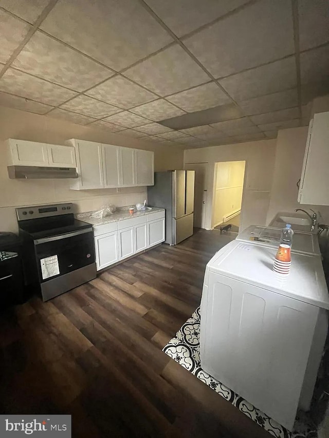 kitchen with dark wood-type flooring, washer / dryer, stainless steel appliances, and white cabinetry