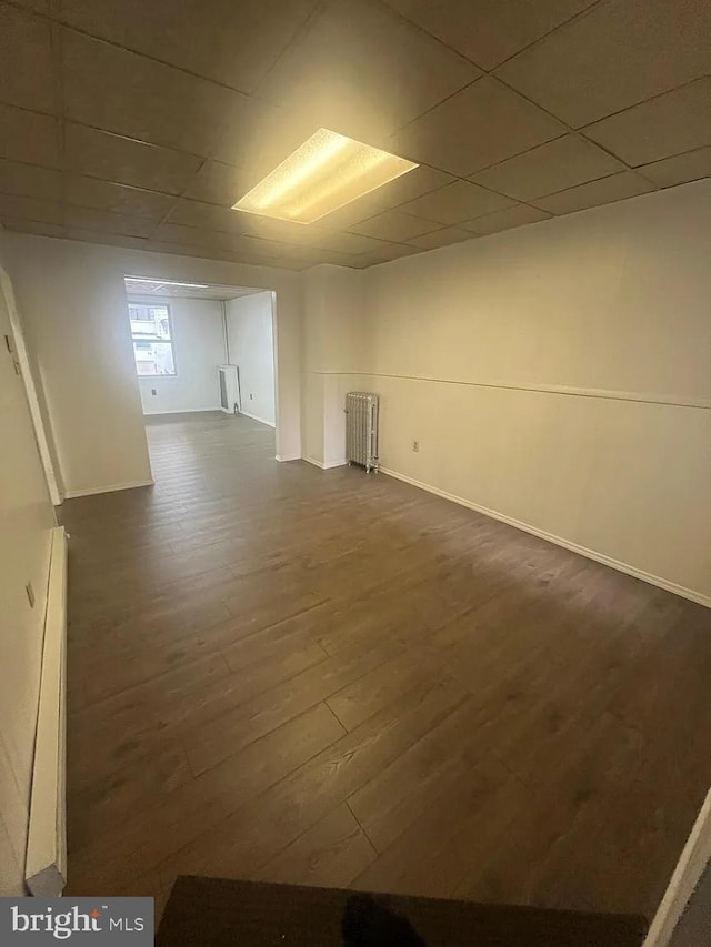 basement featuring radiator and dark wood-type flooring