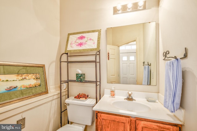 half bath featuring toilet and vanity