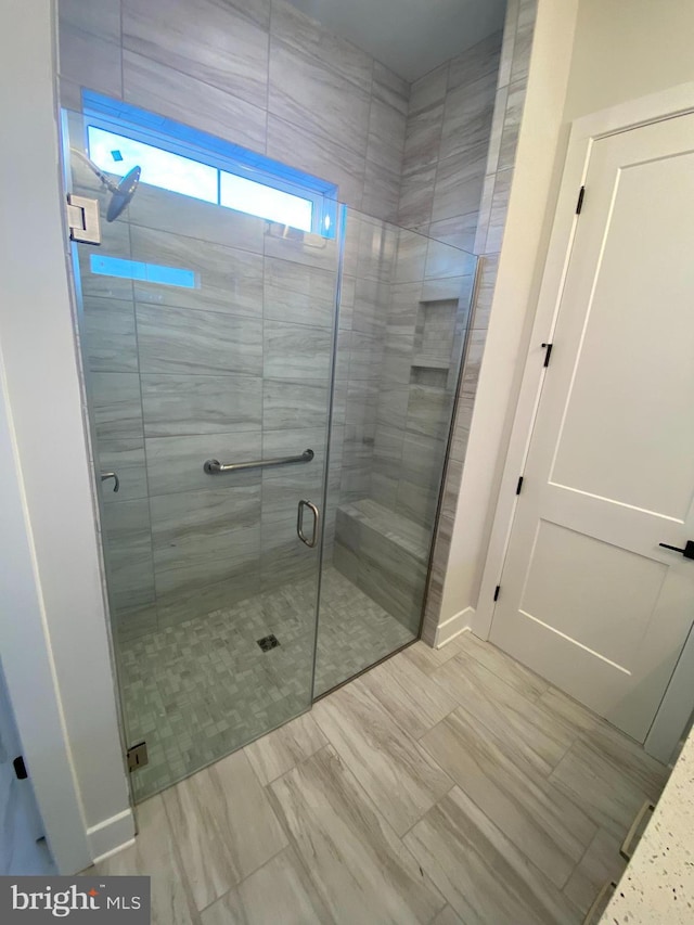 bathroom with a shower with shower door