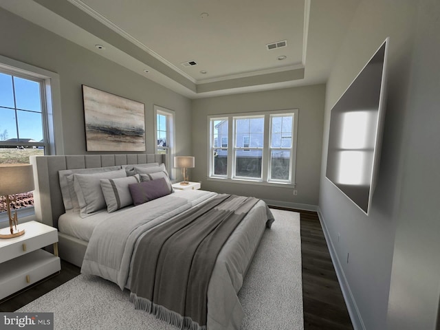 bedroom featuring dark hardwood / wood-style flooring, a raised ceiling, multiple windows, and crown molding