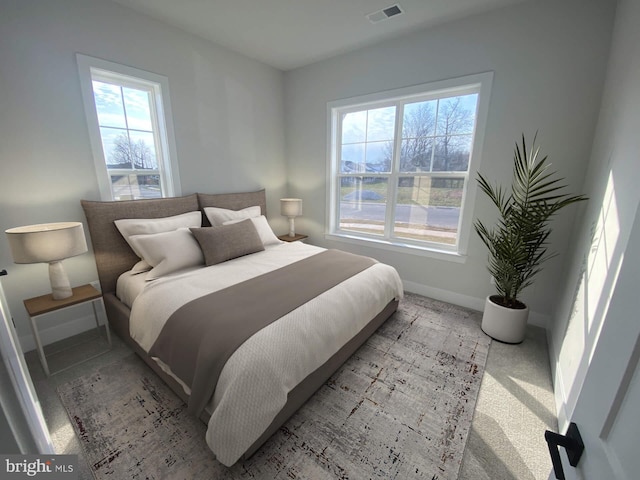 bedroom with light colored carpet