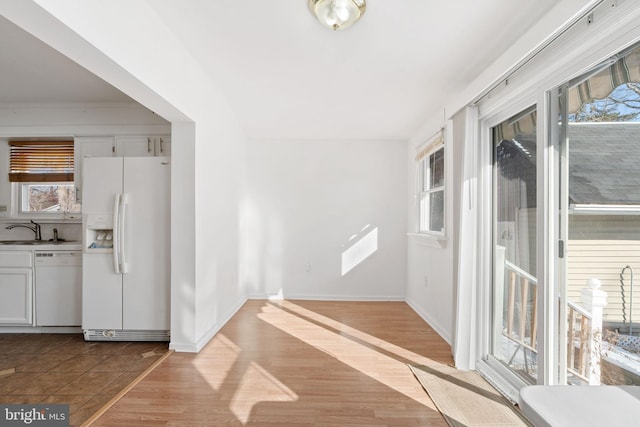 interior space with sink, light wood-type flooring, and plenty of natural light