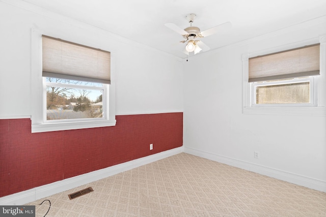 empty room with ceiling fan and ornamental molding