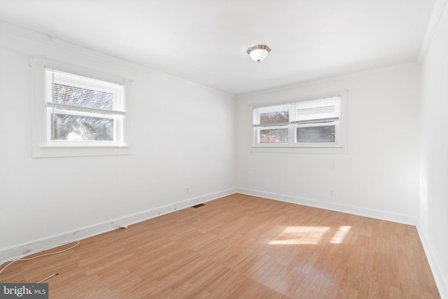 unfurnished room featuring wood-type flooring and crown molding