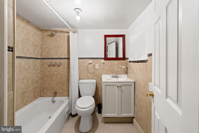 full bathroom with tile walls, shower / bathtub combination with curtain, toilet, and vanity