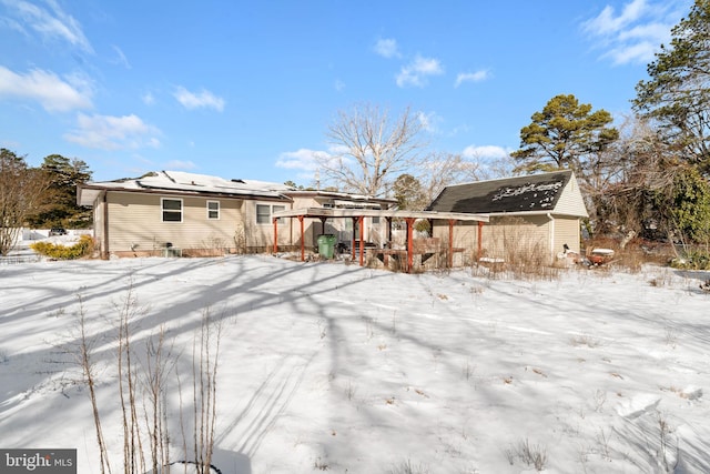 view of snow covered rear of property